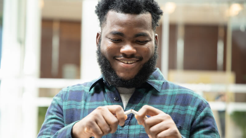 Man smiling getting rid of cigarettes.